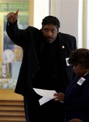 Rev. Dr. William Barber, president of the North Carolina NAACP gives a thumbs up from the gallery of the House chamber of the North Carolina General Assembly where lawmakers debated and voted on voter identification legislation in Raleigh, N.C., Wednesday, April 24, 2013. (AP Photo/Gerry Broome)