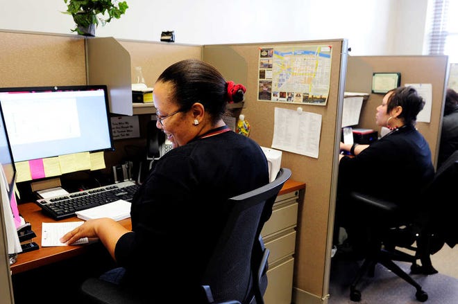 Peccola Turner (left) takes calls in the offices of Augusta Cares at the ninth floor of the municipal building. Beginning June 1, the customer service line can be reached by dialing 311.