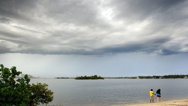 Storm clouds along the beach near the Southern Boulevard Bridge.