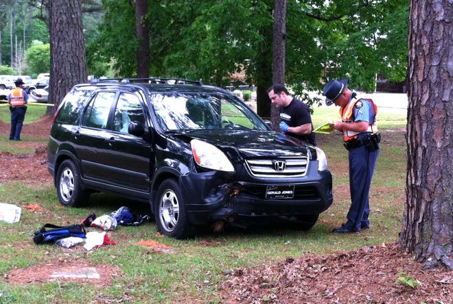 Columbia County Sheriff's Office personnel investigate a single-car wreck on Ray Owens Road in front of North Columbia Elementary School.