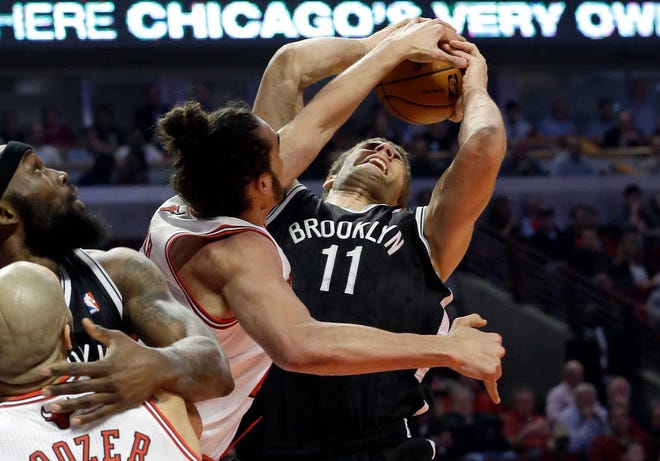 Chicago's Joakim Noah defends a shot by Brooklyn's Brook Lopez during the first half.