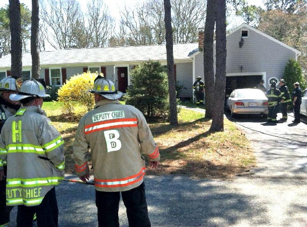 Firefighters work at a garage fire Wednesday morning at 65 Ryder Road in North Harwich.