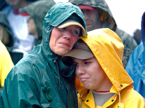 FILE - During a moment of silence, Joan Olsen, left, and her daughter Emily Olsen embrace at the start of the Walk for Suicide Awareness in Kaukauna, Wis., on Sept. 11, 2010. Joan and Emily are honoring Chris Olsen, who is Joan's husband and Emily's father. The suicide rate among middle-aged Americans climbed a startling 28 percent in the decade between 1999 and 2010, the government reported Thursday, but the rates in younger and older people did not change. (AP Photo/Post-Crescent Media, Dan Powers)