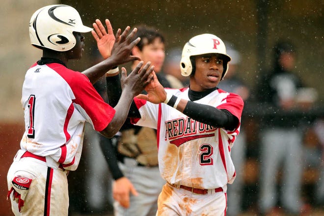 Brandyn Quiller (right) celebrates with Terrance Hillary after scoring a run inFox Creek's huge fifth inning Saturday.