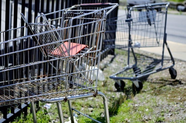 Shopping carts from Walgreens and Giant Eagle sit against a fence at the corner of Rhode Island Avenue and Madison Street behind Rite Aid in Rochester. Borough police posted a notice recently on their Facebook social media site reminding local shoppers that it is a crime under state code for someone to remove a shopping cart
