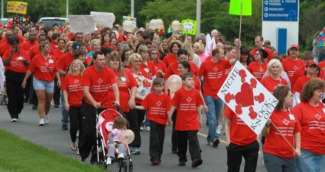 Hundreds of people walk together during CaroMont Regional Medical Center’s Heart Walk on the campus of CaroMont Regional Medical Center on Thursday.