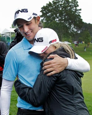 Derek Ernst, left, embraces his girlfriend Alison Ross, right, after winning the Wells Fargo Championship golf tournament at Quail Hollow Club in Charlotte on Sunday. Ernst defeated David Lynn after making par on the first playoff hole.