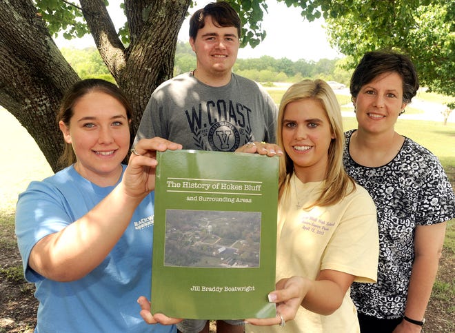 Hokes Bluff High School history teacher Jill Boatwright, right, is pictured Tuesday with seniors, from left, Amy King, Keaton
Langdale and Courtney Entrekin at Hokes Bluff High School. Boatwright and her students have compiled information and published a book detailing the history of Hokes Bluff.