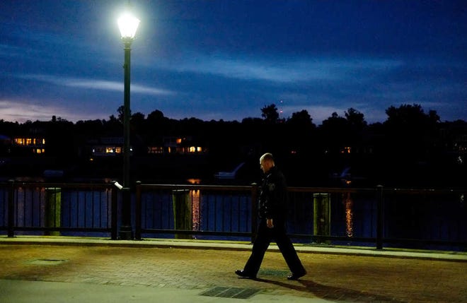 Richmond County sheriff's Deputy Ryan Ferguson walks along Riverwalk Augusta. An attack on a couple there Friday has business owners worried that people will avoid downtown until they feel safer again.