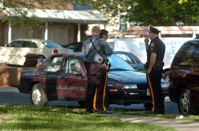 Mount Laurel and State Police stand next to Chevy, which was later towed, on Chaucer Court in Mount Laurel.