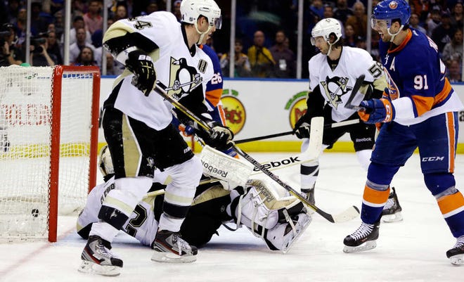 New York's John Tavares (right) beats Pittsburgh's Marc-Andre Fleury for a goal in the second period. He scored twice as the Islanders defeated the Penguins.