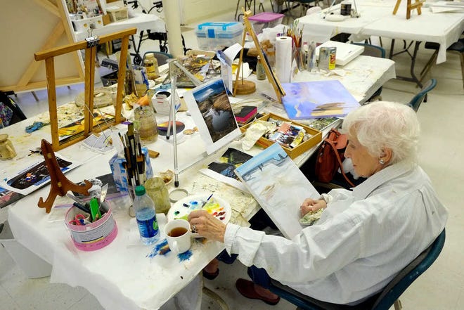 Dorothy Goodwin works on a painting at the community center on Merry Street that is home to the Ageless Artists. The group of about 22 senior citizens get together twice a week to paint and socialize.
