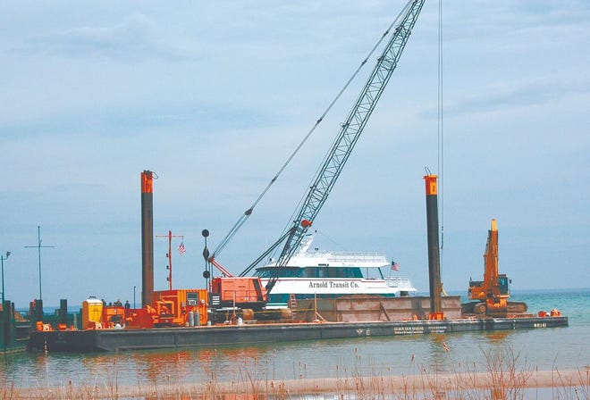 The annual task of dredging harbors is underway to compensate for low water levels in the Great Lakes. A barge and crane worked last week at the Arnold Dock in Mackinaw City to keep the water deep enough for ferryboats to operate. Lake levels are expected to rise somewhat throughout the spring as melting snow and seasonal rains flood creeks and rivers leading to the lakes.