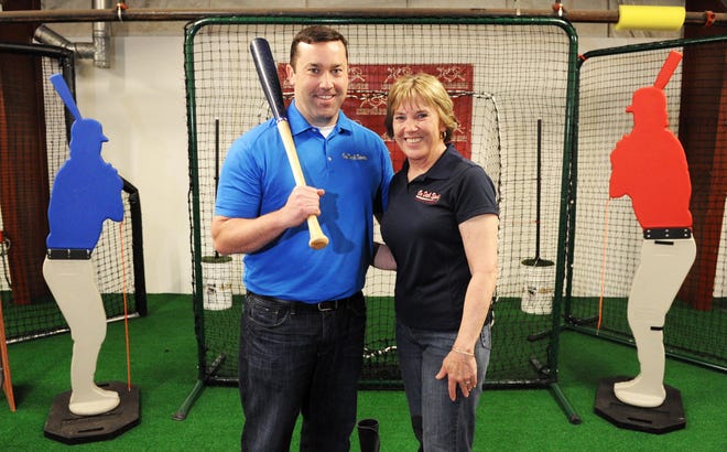 Joe Murphy, left, and his mother Christine Murphy, 62, Holbrook, at his business, On Deck Sports in Brockton.
