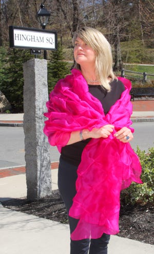 Jane Hoffman models prom attire available at her consignment shop in Hingham.