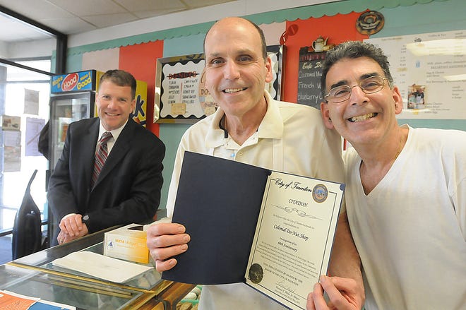 Mayor Thomas Hoye Jr. presents Colonial Do-Nut owners Mike and Bob George with a City of Taunton Citation in recognition of their 60 years in business and their contributions to the city.