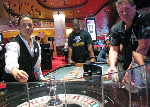 FILE - In this May 21, 2012 file photo, a dealer at Revel prepares for another round of roulette at the Atlantic City, N.J., casino as patrons await the result. Commercial casinos in the U.S. have made it almost all the way back from the hard times of the Great Recession. The American Gaming Association says revenue at non-Indian casinos hit $37.3 billion last year, just a shade under the all-time high reached in 2007. However, New Jersey experienced the largest decline in casino revenue, despite adding a 12th casino, Revel, which filed for Chapter 11 bankruptcy protection after less than a year of operation. Furthermore, Atlantic City’s casinos were hurt by the after-effects of Superstorm Sandy, which kept many visitors away from months after the Oct. 29 storm. (AP Photo/Wayne Parry, File)