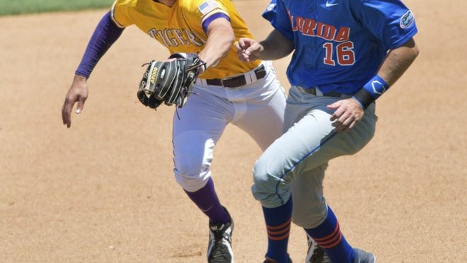 LSU second baseman JaCoby Jones, left, tags out Florida’ Justin Shafer, after Jones fielded a ball near Shafer’s path to second base in the top of the sixth inning of a game Saturday in Baton Rouge, La. Jones also threw out the batter, Zack Powers ,on the same play. Despite being swept by LSU, Florida has bounced back from a slow start to the season. (AP Photo/The Advocate, Travis Spradling)