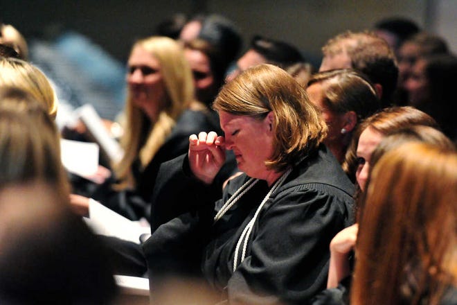 Elizabeth Prince-Coleman (center) realizes she is the recipient of the $25,000 Beard Award for Compassionate Care at Georgia Regents University's College of Allied Health Sciences Hooding and Honors ceremony.