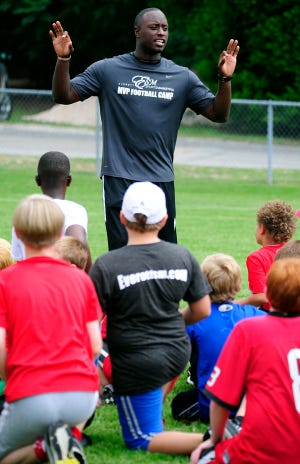 AUGUSTA CHRISTIAN SCHOOL FOOTBALL CAMPS: Former UGA football player D.J. Shockley talked to kids during a 2012 football camp at Augusta Christian School, where several football camps are planned this summer.