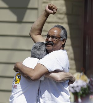 Felix DeJesus pumps his fist and hugs someone as his daughter, Gina, arrives home.