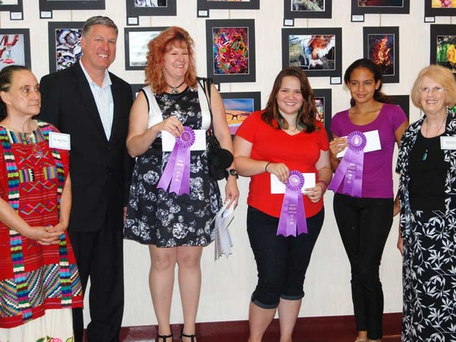From left, Dr. Jane Owen, Mayor Adam Barringer, teacher Tina Curry who was accepting the Best of Show award for Shanleigh O’Dell, Best of Show winners Helena Paciga and Milena Da Cruz and Regina Wise.