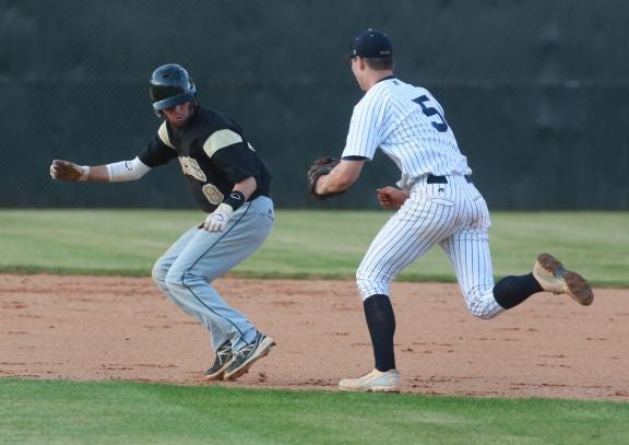 Burns' Ethan Carpenter chases down North Gaston's Mason Smith to tag him out during Thursday night's game at Burns.