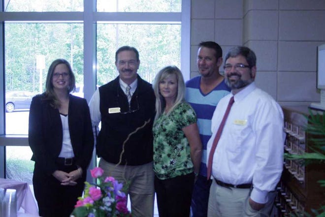 Scott Thompson/Bryan County Now Richmond Hill Middle School Teacher of the Year Tracy Thompson (center) is pictured with school administrators and her husband after being honored on Tuesday.