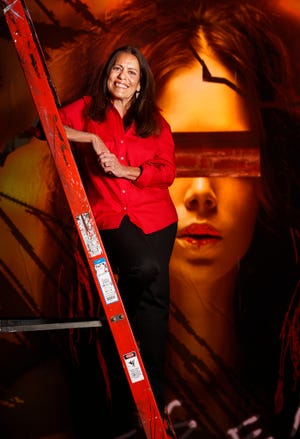 In this Oct. 31, 2012 file photo, Mary Hausch, producing director and co-founder of the Hippodrome State Theatre, poses on the set of Carrie. Hausch is retiring.
