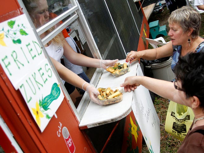 Festivalgoers pick up orders of fried zucchini during the 27th annual Windsor Zucchini Festival. This year’s festival will be from 8 a.m. to 5 p.m. Saturday in Windsor, which is seven miles east of Gainesville on County Road 234. (Brad McClenny/Staff photographer/file)