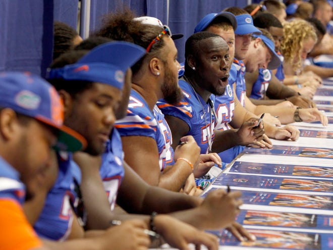 Florida football players sign autographs at last year's fan day experience, held in the Stephen C. O'Connell Center.