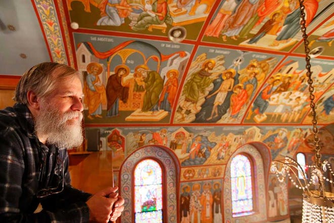 Iconographer Father Theodore Jurewicz looks over the icons he painted over the past six years, which totally cover the interior of the St. Stephen Serbian Orthodox Church in Lackawanna, N.Y.