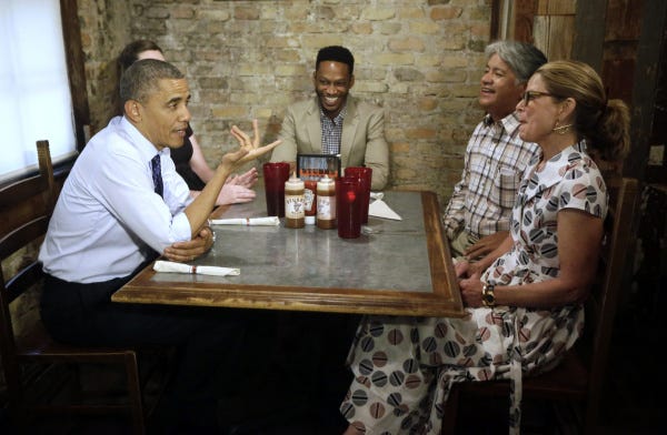 President Barack Obama chats with residents at a restaurant in Austin, Texas. He is on a nationwide trip to showcase efforts to boost economic growth with jobs that benefit the middle class