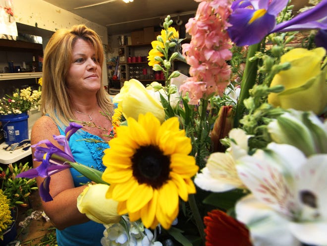 Donna Stanley builds a flower arrangement Wednesday at Zahn's Flowers in downtown Daytona Beach. U.S. consumer spending for the holiday is expected to rise 11 percent this year, compared with last year, according to the National Retail Federation.