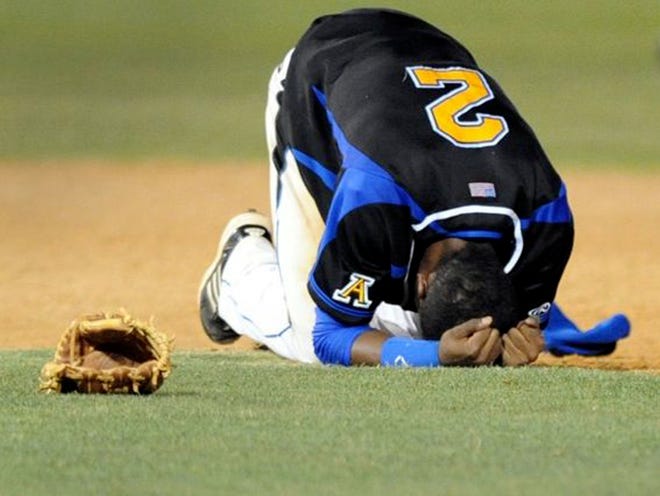 Auburndale's Reyni Olivero drops to the ground after a heartbreaking loss in the regional final at Tampa Jesuit. Auburndale lost 5-4 after giving up two runs in the bottom of the seventh.