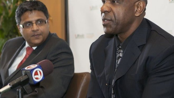 Andre Dawson (right) and Dr. Dipen J. Parekh, chairman of the Department of Urology and director of robotic surgery at Sylvester, who performed the surgery using a device called the da Vinci robot. (Miami Herald photo)