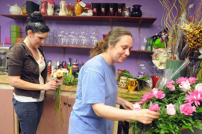 Kristen Bordeaux, left and Nicole Allen work on floral arrangements at Robin's Corner Flower Shop, now located in the Roseland parking lot on Broadway in Taunton.