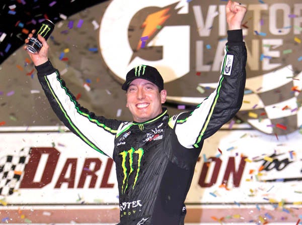 Kyle Busch celebrates his win in the Nationwide race at Darlington, S.C., on Friday. (Mic Smith | Associated Press)
