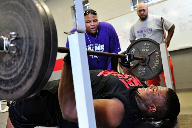 Rodney Tew, a 2011 graduate of Hillgrove High School, completes 18 repetitions of 225 pounds during tryouts for the Paine College football team. The Lions are reviving their football program after a 51-year absence.