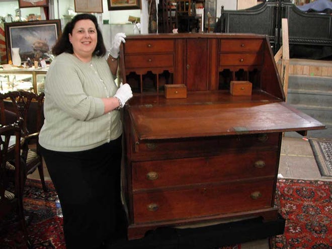 Dr. Lori poses on the set of Discovery channel’s "Auction Kings" with President Thomas Jefferson’s Hepplewhite slant top writing desk.