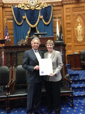 State Rep. John V. Fernandes, D-Milford, and Laura Mann of Milford attend a recent recognition ceremony at the State House in Boston for the state's "Unsung Heroines."