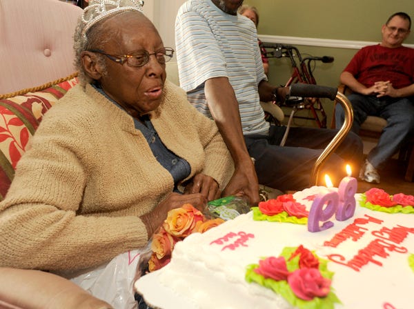 Corine Williams blows out the candles on her cake Friday during her birthday party at Daugette Towers in Gadsden. Williams, mother of five, was celebrating her 89th birthday.