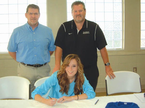 Westbrook Christian's Julie Williams signs a soccer scholarship with Faulkner University. Standing behind are are Westbrook coach Richard Dobbs, left, and Faulkner coach Glenn Townsend.