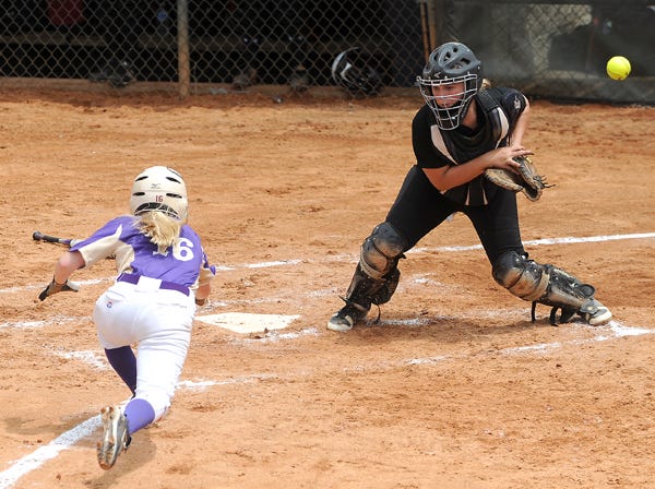 Gaston’s Darby Samples can’t handle a throw as Lexington’s Jessie Butler slides home in the Class 2A North Regional softball tournament at the Metro Kiwanis Sportsplex in Huntsville on Saturday.