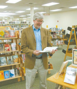 Randy Wilson gets a head start on the reading he plans to do after retiring as director of the Parlin-Ingersoll Public Library after more than 30 years. A reception for Wilson will be held from 3 tp 6 p.m. Thursday, May 23, at the library.