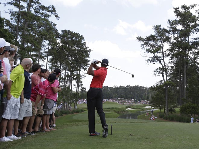 Tiger Woods hits from the fifth tee during the final round of The Players championship golf tournament at TPC Sawgrass, Sunday, May 12, 2013, in Ponte Vedra Beach, Fla. (AP Photo/John Raoux)