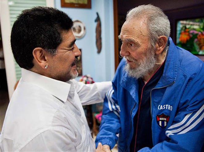In this picture image released by Cuba's state newspaper Granma on Monday April 15, 2013, Cuba's Fidel Castro shakes hands with former soccer star Diego Maradona in Havana, Cuba, Saturday April 13, 2013. .