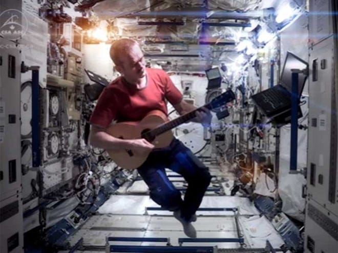 In this screen capture from his video, astronaut Chris Hadfield sings the David Bowie song "Space oddity" about the International Space Station.