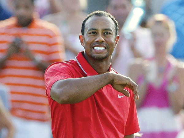 Tiger Woods pauses on the 18th green after winning the Players Championship on Sunday.
(Gerald Herbert | Associated Press)