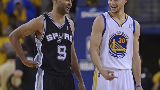 The Golden State Warriors’ Stephen Curry chats with the San Antonio Spurs’ Tony Parker at the start of overtime in Game 4 of the Western Conference playoffs. A calf injury might hamper Parker’s effectiveness.